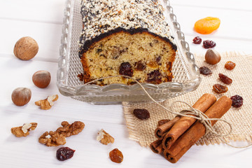 Fresh baked fruitcake with ingredients on boards