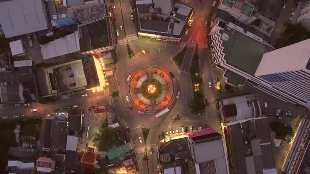 Motion Timelapse of Traffic on Roundabout at Dusk, Aerial View From Above
