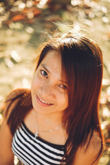 Beautiful portrait of young Asian woman smiling, with nice sunlight