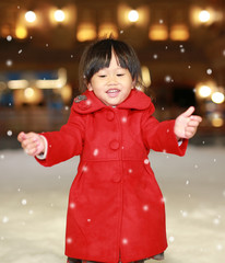 Close up Little girl wearing a red jacket has a fun in snow, Winter time.
