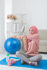 woman stretching while doing exercise at home