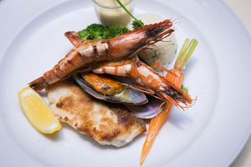 Pan Sear Sea bass, Tiger Prawn, NZ Mussel, Garlic Rice with Market Vetetable and Cream Leek Sauce