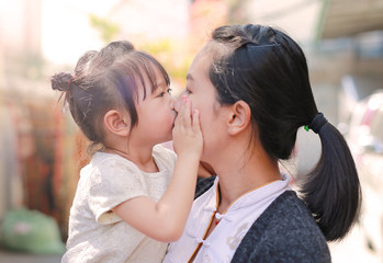 Happy loving family. mother and child girl kissing.