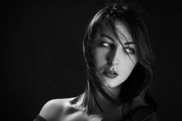 sensual woman with bare shoulders on black background, monochrome