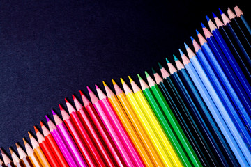 Color pencils isolated on black background