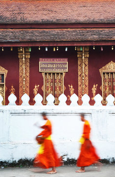 Dawn procession of monks receiving alms from townspeople in Luang Prabang. Laos