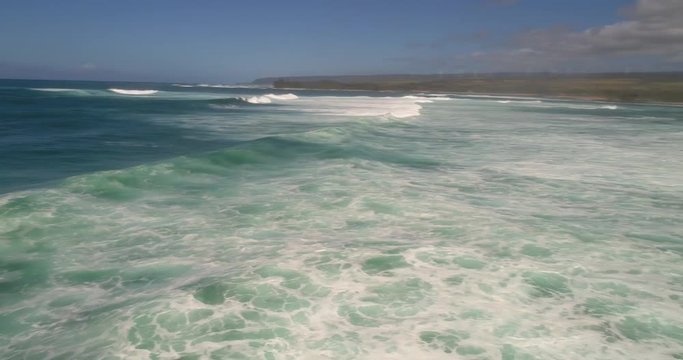 Aerial drone over wves on the beach