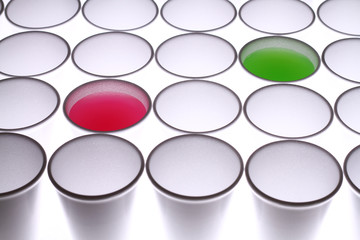 white cups and red, green water