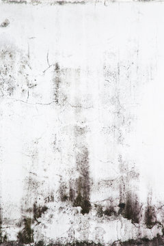 Texture of grey concrete wall with dark water marks running vertically down and many marks and lines