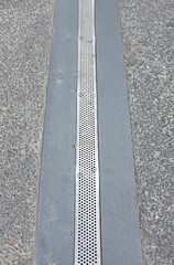 Iron grate of water drain on street.
