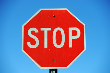 stop sign against blue sky