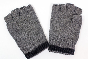 Gray wool fingerless gloves on white background