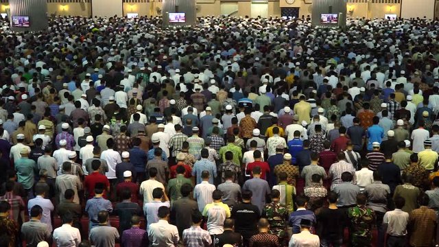 Video footage of muslim men praying together on the Friday prayer time in mosque