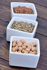 Different beans in a ceramic bowls on table