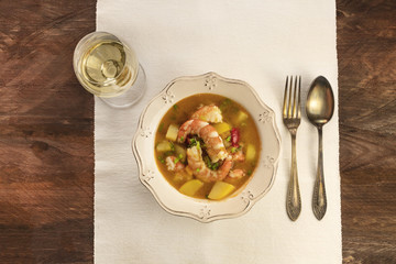 Shrimp and potato dish with wine and copyspace
