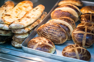 Turkish Pastries Pogaca and Pide at patisserie showcase.