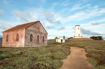 Fototapeta premium Pathway by Red Brick Fog Signal Building at the Piedras Blancas Lighthouse on the Central California Coast USA