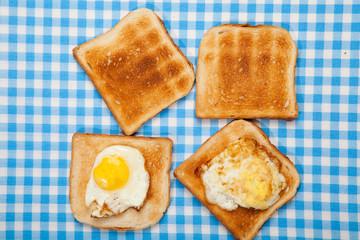 Breakfast. Toast and eggs on a blue table