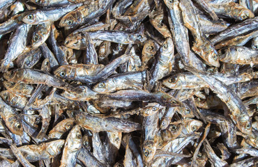 Small dried fishes on market table for sell. Sea mackerel on display.