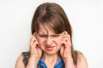 Woman covering her ears to protect from loud noise