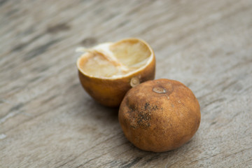 .Haggard ripe lemon drop on a brown wooden floors. Wood saw clear And the shape of a lemon.