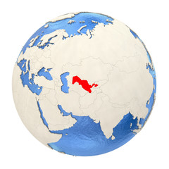 Uzbekistan in red on full globe isolated on white