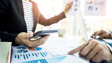 Team work process. young business managers crew working with new startup project. labtop on wood table, typing keyboard, texting message, analyse graph plans