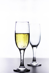 glass of white wine on a table on white background isolate