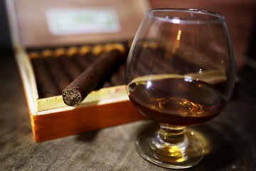 Large box of Cuban cigars on a wooden table