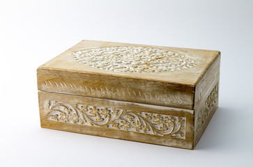 Wooden carved box on white background