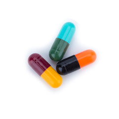 Three capsule color Red Yellow Blue Green Orange and Balck isolated on white background