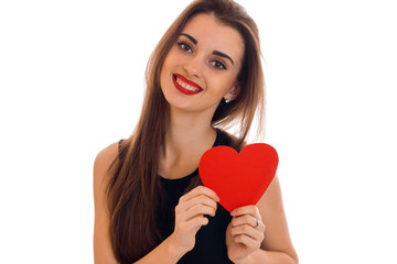 happy young brunette woman with red lips and heart in her hands posing isolated on white background