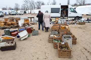 People Looking for Used Goods in Boxes at Flea Market