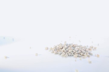 Little White Stones in a Small Pile Isolated on White Background