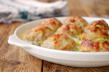 Meatballs in a white sauce. Food Photography. Wooden background.