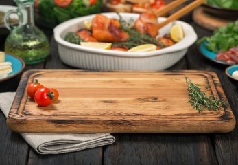 Cutting board on wooden table with free place for you