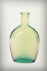 Old colourful bottles against a white background