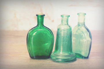 Coloured glass bottles on a rustic background