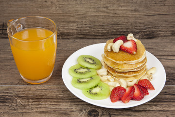 Pancake with strawberry topping and kiwi, delicious dessert