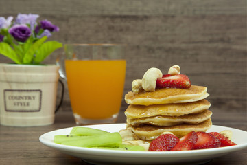 Strawberry pancake and kiwi with orange juice