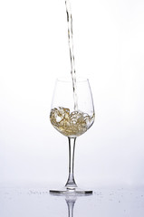 Pouring beer into wine glass on white backgrounds
