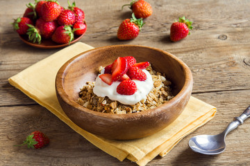 Homemade granola with yogurt and strawberries