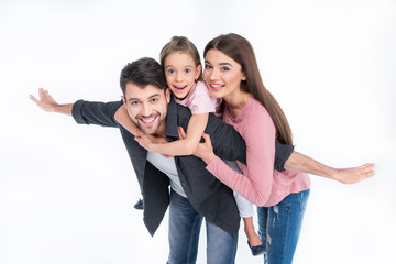 Fototapeta premium Happy young family with one child having fun together on white