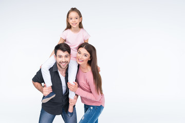 Fototapeta premium Happy young family with one child having fun together on white