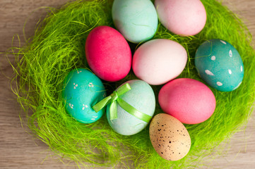 Easter composition of colored eggs cooked for the holiday on the wooden background