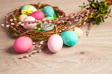 Fototapeta na wymiar Easter composition of the branches,Easter bunny, cakes, tulips colored eggs cooked for the holiday on the wooden background