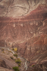 River flowing through deep orange colored canyon, covered by volcanic ash in Peru, South America.