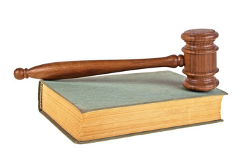 Wooden mallet and book on a white background