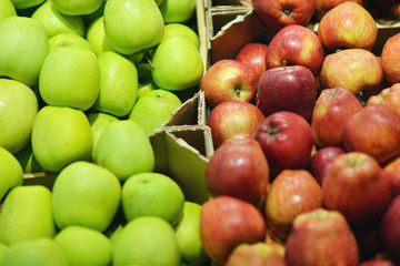 Green and red apples on shelf in market