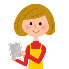 タブレットを触るエプロンの女性  